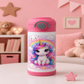 A pink and white insulated water bottle with a cute cartoon unicorn design, set on a white table in a cozy pink children's room background.