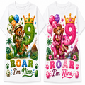 Two white short-sleeve T-shirts shown side by side, each with a colorful cartoon birthday graphic. The left shirt features a green dinosaur and bear with a green number 9 and the text 'ROAR I'm Nine'.