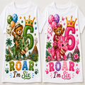 Two white short-sleeve T-shirts shown side by side, each printed with a colorful dinosaur-themed '6 Roar I'm Six' graphic featuring cartoon bears, balloons, stars, and jungle elements.