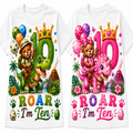 Two white short-sleeve T-shirts shown side by side, each with a colorful cartoon dinosaur birthday graphic. The left shirt features a green dinosaur and bear with a green '10' and the text 'ROAR I'm Ten' in green, yellow, and blue.