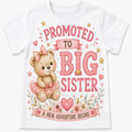 A white short-sleeve baby t-shirt featuring a cute graphic print of a teddy bear wearing a pink tutu and bow, surrounded by the text 'PROMOTED TO BIG SISTER' and 'A NEW ADVENTURE BEGINS' in pink and brown lettering with floral and star accents.