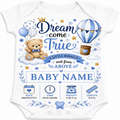 White baby bodysuit with a blue and brown personalized baby shower graphic featuring a teddy bear, hot air balloon, stars, and text fields for baby name, date, time, weight, and length.