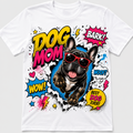 A white short-sleeve crewneck t-shirt featuring a colorful comic book-style graphic of a French Bulldog wearing red sunglasses, surrounded by bold text like 'DOG MOM', 'BARK!', 'WOOF!', and 'BEST DOG EVER!'.
