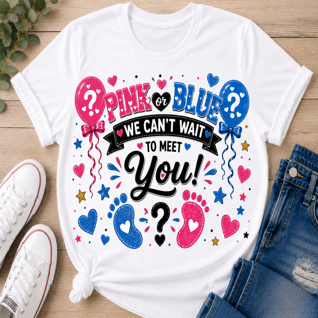 A white graphic t-shirt laid flat on a wooden surface, styled with white sneakers and blue jeans. The shirt features a colorful design with pink and blue balloons, hearts, stars, and baby footprints around the text 'PINK or BLUE WE CAN'T WAIT TO MEET You!'.