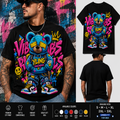 A black short-sleeve graphic T-shirt shown on a male model from multiple angles, plus a standalone front view of the shirt. The shirt features a large colorful teddy bear illustration with graffiti-style text reading 'VIBES BIZ' and bright neon accents in blue, pink, yellow, red, and white.