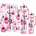 A set of pink floral insulated tumblers with a black cursive 'faith' script printed on the front, shown in multiple sizes alongside a matching square wrap or mat. The design features pink poppy flowers and delicate black line drawings on a white background.