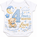 White short-sleeve baby bodysuit with a colorful 'Four Months of Love' graphic featuring a large quilted blue number 4, a teddy bear, a crescent moon, stars, clouds, and floral details.