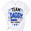 A white short-sleeve crewneck t-shirt with a graphic print that reads 'TEAM DADDY BABY LOADING.