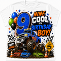A white short-sleeve t-shirt featuring a colorful graphic design for a nine-year-old boy's birthday. The design includes a large blue number 9, the text 'NINE COOL I'M BIRTHDAY BOY!', a blue monster truck, small race cars, balloons, checkered flags, and cones.