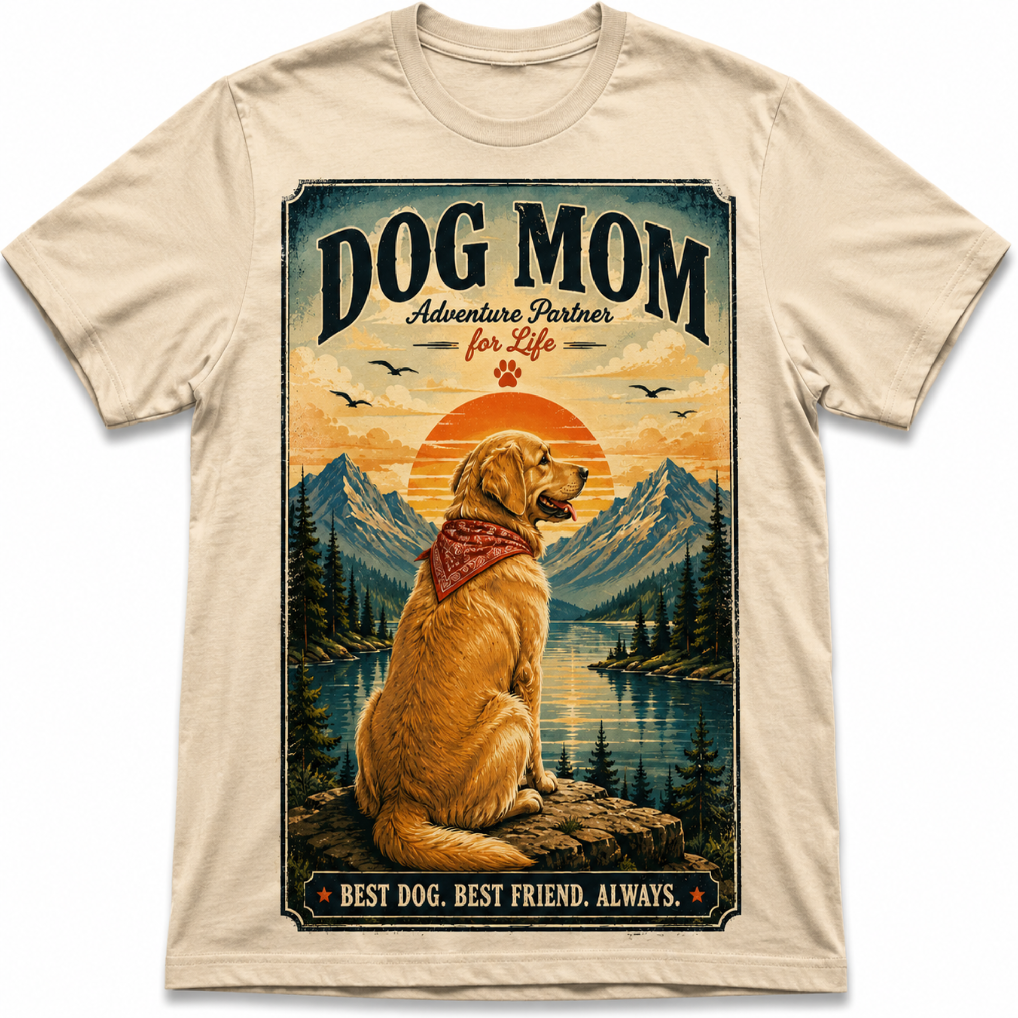 A beige crewneck t-shirt featuring a large graphic print of a golden retriever dog sitting in front of mountains and a lake, with the text 'DOG MOM Adventure Partner for Life' and 'BEST DOG. BEST FRIEND.