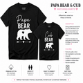 Matching black t-shirts for 'Papa Bear' and 'Cub Bear' displayed side-by-side with descriptive text and feature callouts on a white background. The left shirt shows a large white 'Papa Bear' text and bear graphic, while the right shirt shows a smaller 'Cub Bear' text and bear graphic.