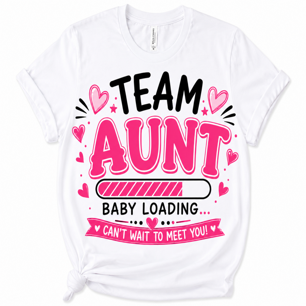 A white short-sleeve t-shirt with a graphic print that reads 'TEAM AUNT BABY LOADING CAN'T WAIT TO MEET YOU!' in black and pink lettering with heart and star accents, shown on a plain white background.