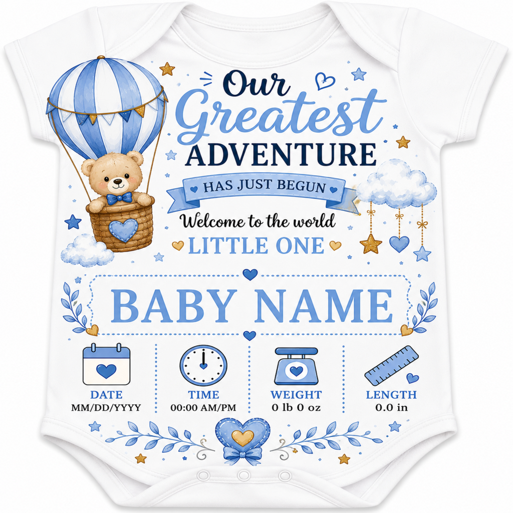 A white short-sleeve baby bodysuit featuring a blue and navy blue graphic print with a teddy bear in a hot air balloon, clouds, stars, and baby milestone icons. The text reads 'Our Greatest ADVENTURE HAS JUST BEGUN Welcome to the world LITTLE ONE BABY NAME' with placeholder date, time, weight, and length fields at the bottom.