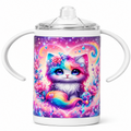 A white handled baby tumbler with a clear lid, featuring a colorful printed illustration of a fluffy pastel kitten surrounded by flowers and a rainbow on a starry purple background.