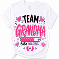 A white short-sleeve t-shirt with a graphic print that reads 'TEAM GRANDMA BABY LOADING.
