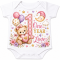 White baby bodysuit with a colorful '1st One Year of Love' graphic featuring a teddy bear, balloons, flowers, and a crescent moon.