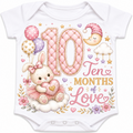 White short-sleeve baby bodysuit with a colorful 10-months-themed graphic print featuring a bunny, balloons, stars, clouds, and the text 'Ten Months of Love'.