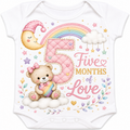White short-sleeve baby bodysuit with a colorful 5-months birthday graphic featuring a large quilted pink number 5, a rainbow, a sleeping teddy bear on a cloud, stars, hearts, and the words 'Five Months of Love'.