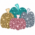 A set of five glittery decorative pumpkins in gold, teal, pink, and silver, arranged together on a plain white background.