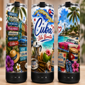 Three tall insulated tumblers with black bases are shown side by side, each printed with a colorful Cuba-themed tropical and street-art style design. The center tumbler reads 'Cuba Isla Bonita' with blue script and red accents, while the side tumblers show beach scenes, palm trees, flowers, and Cuban flags.