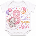 White short-sleeve baby bodysuit with an 'Eight Months of Love' nursery graphic featuring a pink elephant, balloons, a crescent moon, and stars.