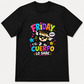 A black short-sleeve crewneck t-shirt with a colorful graphic on the chest. The graphic features the Spanish phrase 'FRIDAY Y EL CUERPO LO SABE' in vibrant, multicolored letters, accompanied by a cartoon illustration of a person wearing sunglasses and a speech bubble that says 'HAMOS'.