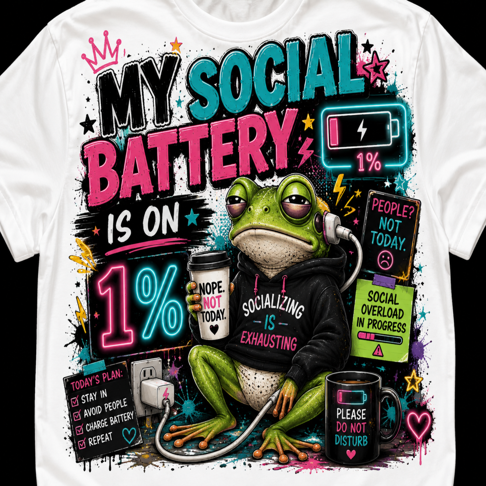 A white short-sleeve graphic t-shirt featuring a colorful cartoon frog wearing a black hoodie and headphones, surrounded by humorous social exhaustion text and stickers. The design includes a battery icon showing 1% charge and the phrase 'MY SOCIAL BATTERY IS ON 1%'.