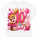 A white short-sleeve kids' t-shirt featuring a colorful '10th Birthday Sweet' graphic print with a teddy bear, cupcakes, balloons, stars, and a crown.