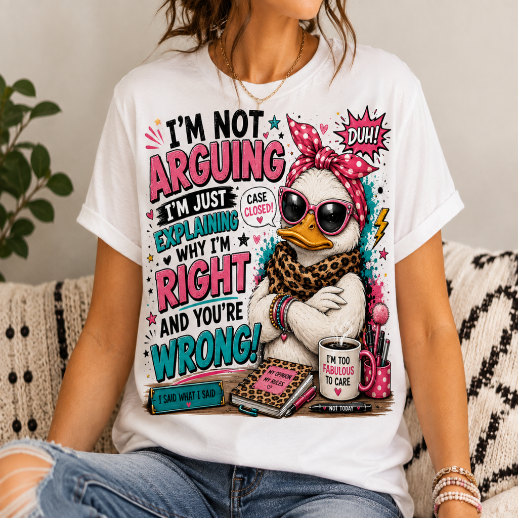 A woman wearing a white graphic t-shirt with a colorful cartoon duck design and text that reads 'I'M NOT ARGUING I'M JUST EXPLAINING WHY I'M RIGHT AND YOU'RE WRONG!'.