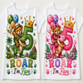 Two white short-sleeve baby t-shirts shown side by side, each with a colorful cartoon birthday graphic. The left shirt features a green dinosaur and a teddy bear with balloons, a large number 5, and the text 'ROAR I'm Five' in green.