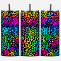 Three tall insulated tumblers with clear lids and metal straws, featuring a bright rainbow gradient background with a black leopard print pattern, shown against a plain white background.
