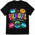 A black short-sleeve crewneck t-shirt featuring a colorful graphic design celebrating bilingualism. The graphic includes the text 'HABLO ESPAÑOL', 'I SPEAK ENGLISH', 'BILINGUAL', 'DOS IDIOMAS, MIL POSIBILIDADES', 'MI CULTURA MI ORIGEN', and 'MY CULTURE MY PRIDE' in vibrant, playful fonts around a cartoon globe character wearing heart-shaped sunglasses.