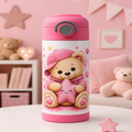 A pink insulated water bottle with a cartoon teddy bear and star design, set on a white table in a pink-themed room with teddy bears and shelves in the background.